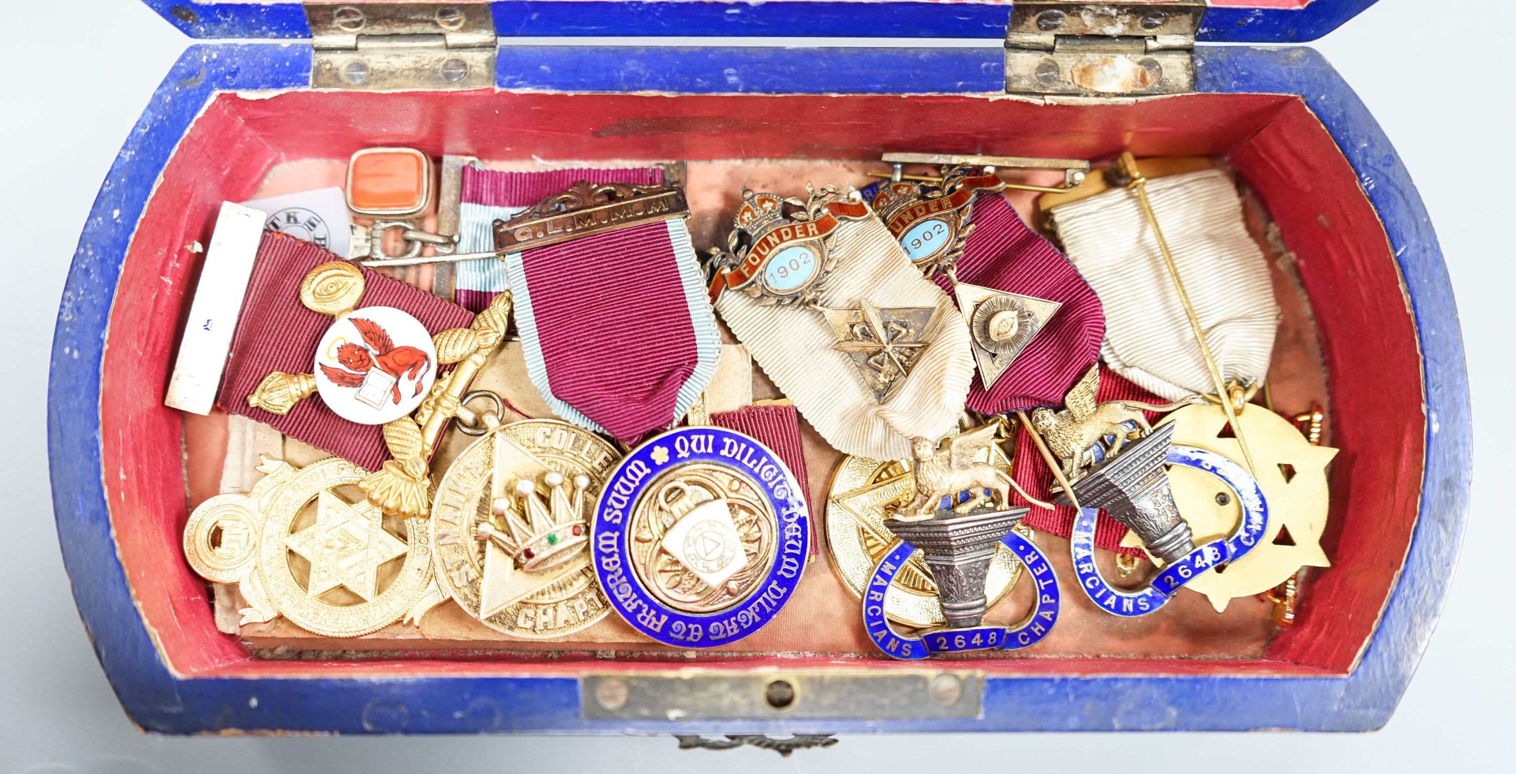 A group of Masonic medals some silver gilt, in a painted wood box